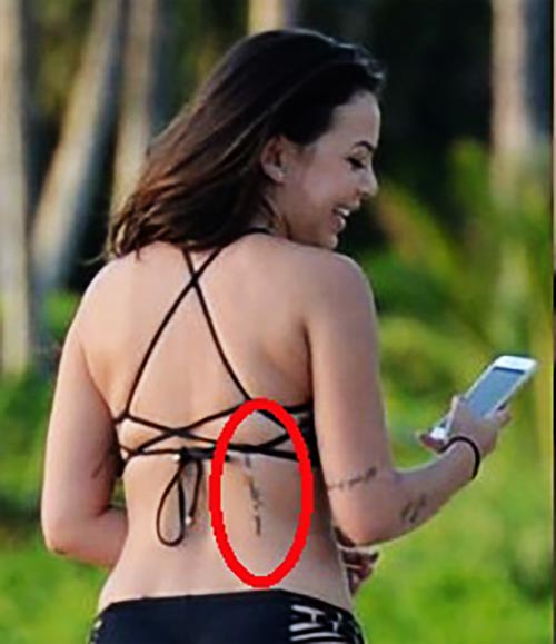 Janel Parrish has a writing tattoo on her lower back