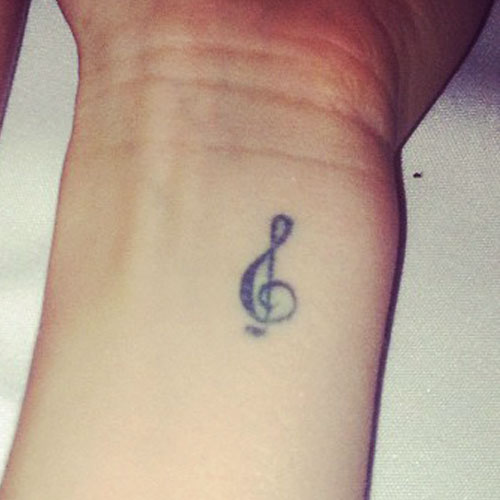 Janel Parrish treble cleft tattoo
