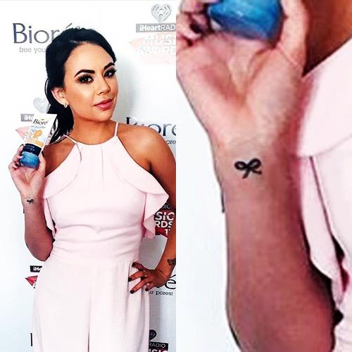 Janel Parrish's bow tattoo on her right wrist