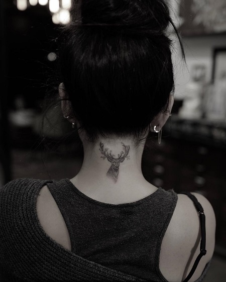 Janel has buck tattoo on her neck