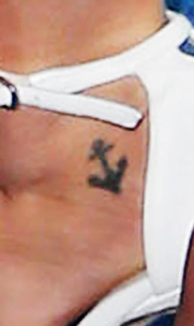 Janel has tattooed anchor on her ankle