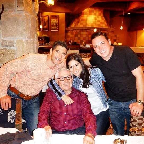 Romi with her two older brothers and her father